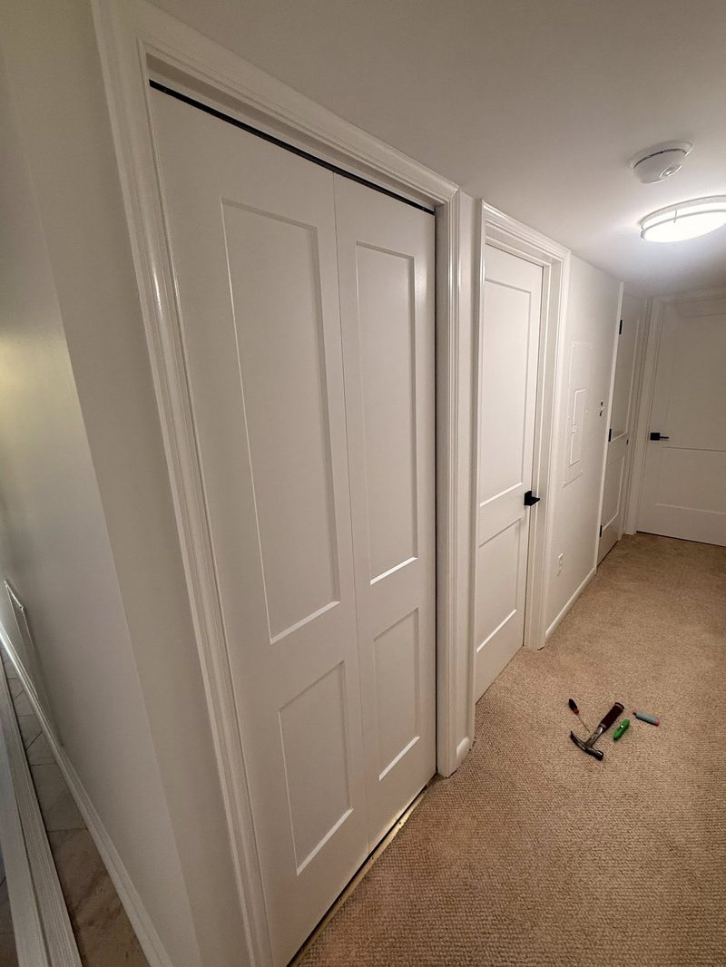Eight new interior doors installed down the hallway of an Avalon home