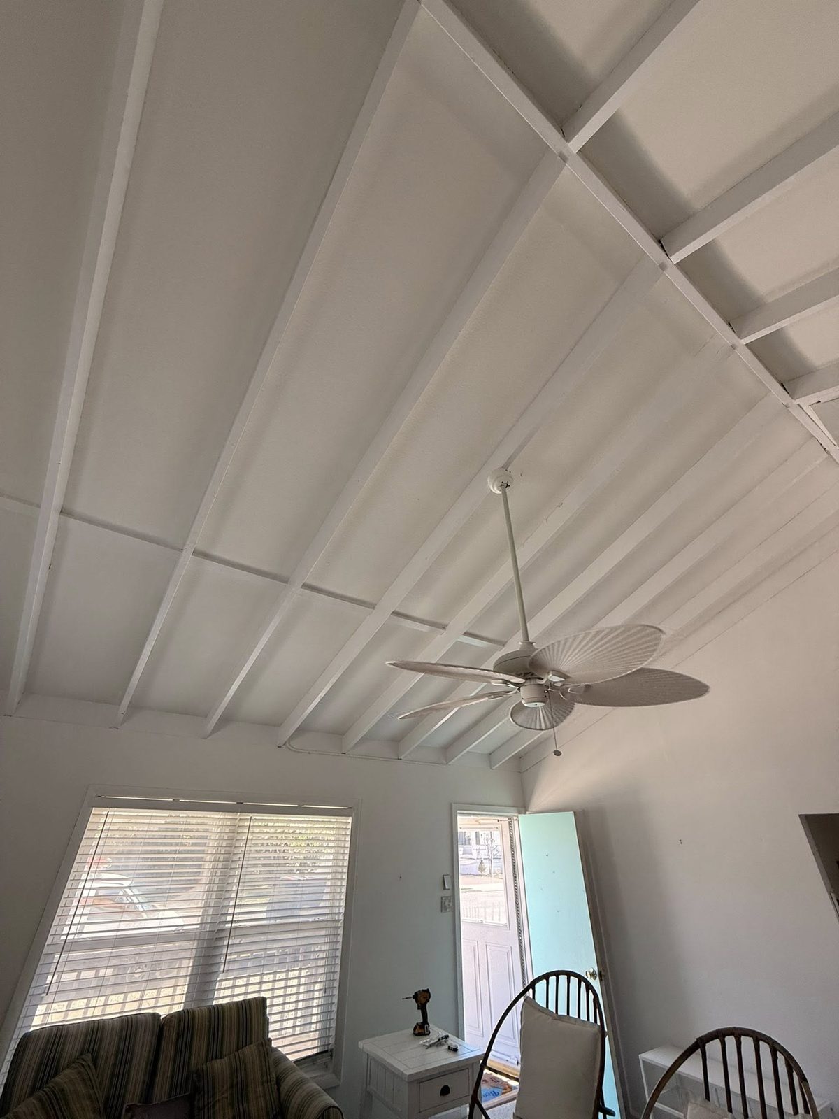 Beam ceiling repainted: bright white field, dark accent beams crisp