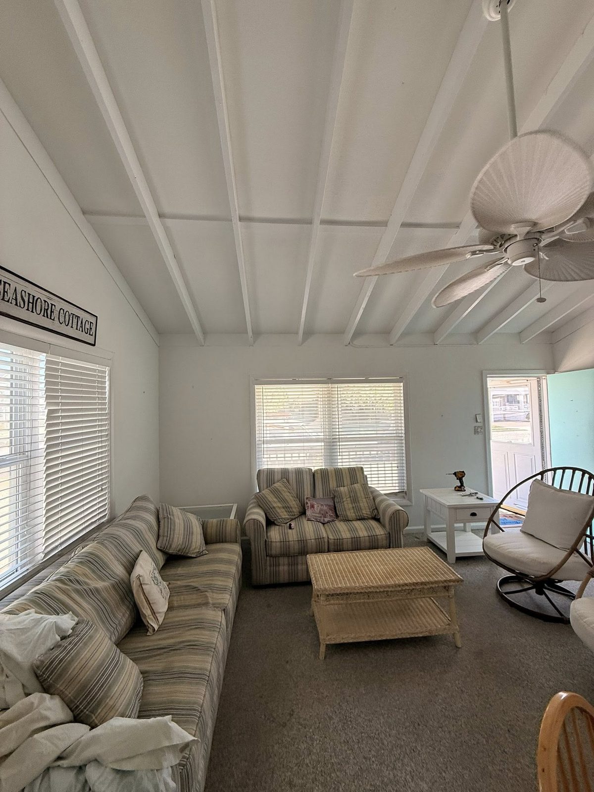 Living room interior repaint finished, neutral wall color throughout